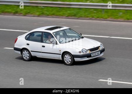 1998, 90s, novanta Toyota Corolla Gs bianco berlina 1597cc benzina berlina berlina berlina; viaggiando sull'autostrada M61, Regno Unito Foto Stock