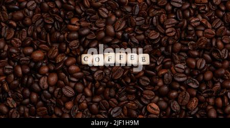 la parola caffè nel mezzo di un sacco di caffè in grani Foto Stock