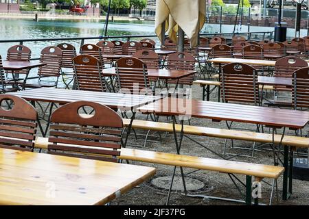 Sedie e tavoli vuoti in un attraente ristorante all'aperto sulle rive del reno, la carenza di personale dopo la corona pandemic diventa problematico fo Foto Stock