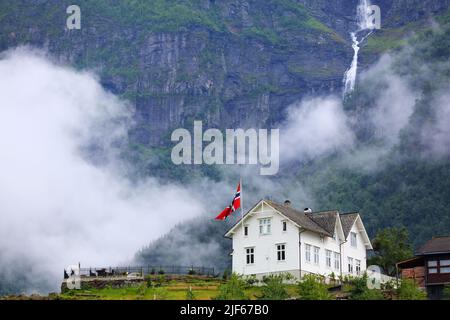 Ullensvang città in Norvegia. Montagne Misty e una cascata. Paesaggio norvegese. Foto Stock