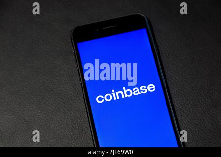 Logo di Coinbase Crypto scambio su uno schermo del telefono su sfondo di pelle Foto Stock