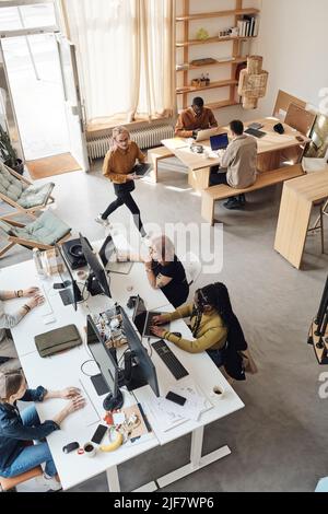 Colleghi aziendali multirazziali che lavorano insieme in società start-up Foto Stock