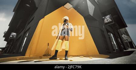 Giovane ed elegante uomo afroamericano che mangia una banana mentre fuori in città da un muro giallo. Concettuale, uomo alla moda fresco che viaggia in città in piedi da un Foto Stock