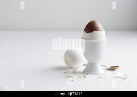 Uovo di cioccolato su supporto bianco con spazio per copiare Foto Stock