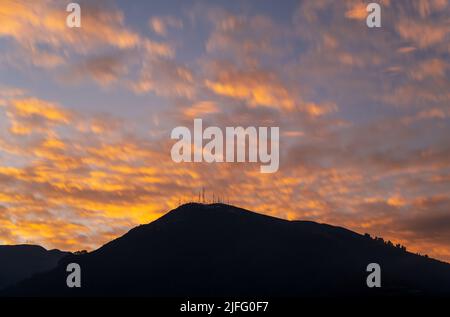 Tramonto a lunga esposizione con il picco dell'antenna (3920m altitudine) del vulcano Pichincha, Quito, Ecuador. Foto Stock