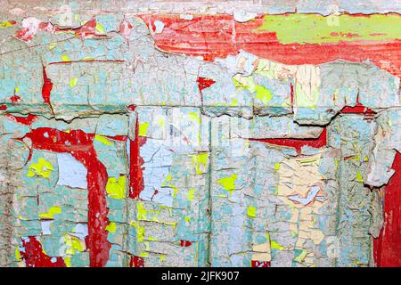 Superficie verniciata pelata . Vecchia vernice multicolore con crepe Foto Stock