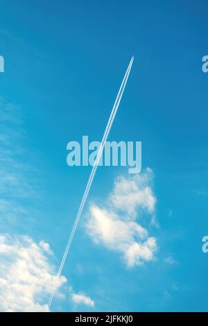 Percorso del vapore dell'aeroplano o modello a contrasto sul cielo blu con le nuvole dal basso Foto Stock