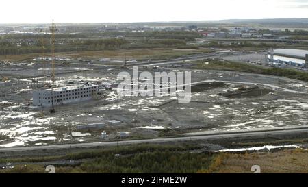 Vista aerea del cantiere. Riprese in stock. Grande cantiere di costruzione con diverse gru che lavorano su un'area di costruzione. Foto Stock