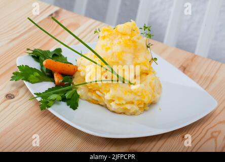 Piatto tradizionale della cucina scozzese - Clapshot serviti con carote cotte e verdi Foto Stock