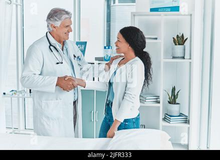 Im contento di avere finalmente un appuntamento. Shot di un medico senior che agita le mani con un paziente in saluto. Foto Stock