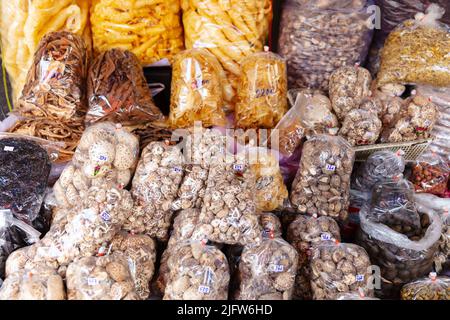 Vari prodotti alimentari confezionati in vendita presso il mercato locale tailandese Foto Stock