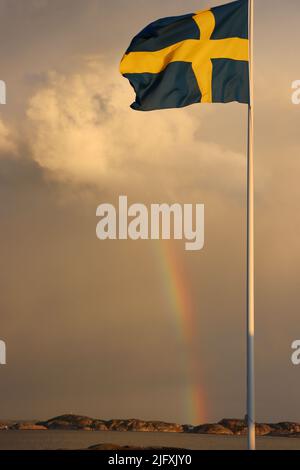 Bandiera svedese e arcobaleno nell'arcipelago di Fjällbacka nel giugno 2022 Foto Stock