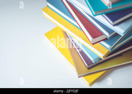 Vista dall'alto pila di libri sul tavolo bianco nella sala libreria con spazio per testo o design Foto Stock