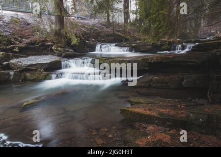 Cascate di ghiaccio gelido nel Beskydy Task nella parte orientale della Repubblica Ceca, nel mezzo dell'Europa. Cascate create naturalmente su una formazione di roccia wi Foto Stock