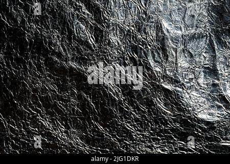 Trama in alluminio argento scuro. Sfondo metallico lucido nero. Foto Stock