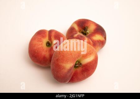 Pesche di ciambella davanti ad uno sfondo bianco giallastro Foto Stock