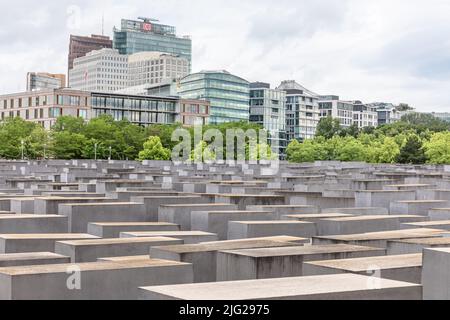 Vista generale del memoriale degli ebrei assassinati d'Europa, noto anche come memoriale dell'Olocausto a Berlino per le vittime ebraiche dell'Olocausto. Il Memoriale agli ebrei assassinati d'Europa, noto anche come Memoriale dell'Olocausto, è un memoriale a Berlino per le vittime ebraiche dell'Olocausto, progettato dall'architetto Peter Eisenman e Buro Happold. Si compone di un sito di 19.000 metri quadrati coperto con 2.711 lastre di cemento o 'telae', disposti in un disegno a griglia su un campo inclinato. Essi sono organizzati in righe, 54 di loro andando northñsouth, e 87 andando eastñwest ad angolo retto, ma impostato leggermente askew Foto Stock