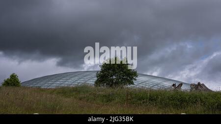 Foto scattata al National Botanic Garden Wales nel luglio 2022 e che mostra il cielo scuro sopra la serra. Foto Stock