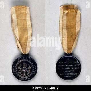 Medaglia commemorativa della spedizione in Italia del 1849, Vaticano. Medaglia commemorativa. Medaglia creata dallo Stato Pontificio, in categorie di oro, argento e bronzo da accordare in distinzione alle milizie di Spagna, Austria, Francia e Napoli che con il loro intervento in Italia, Reso possibile il ritorno a Roma della forma circolare di S. Santità Pio IX, articolata da un attacco di solidarietà con esso, posto nella sua parte superiore, attraverso il quale passa un nastro giallo di seta moaré con due travi bianche, simboli papati, posti uno su ciascun lato, del quale assica la medaglia. Circolare, liscia e. Foto Stock