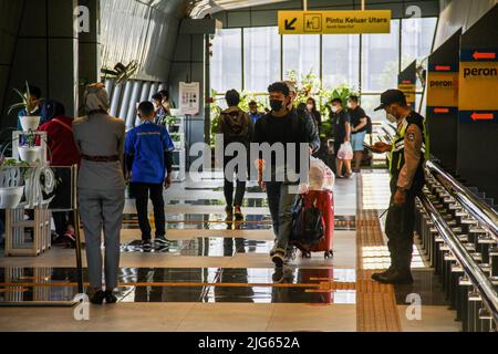 Bandung, Indonesia. 08th luglio 2022. I passeggeri che indossano maschere facciali camminano verso il treno alla stazione ferroviaria di Bandung. Il governo indonesiano implementerà un vaccino di richiamo per il Covid-19 nelle prossime due settimane come requisito per i viaggiatori. Credit: SOPA Images Limited/Alamy Live News Foto Stock