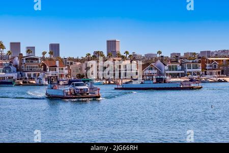 Traghetti che trasportano passeggeri e auto da Balboa Island alla penisola di Newport Beach in California in una giornata di sole Foto Stock