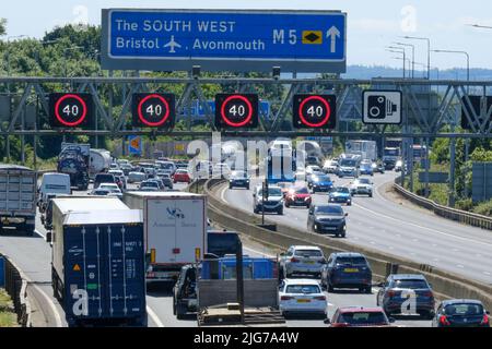 Bristol, Regno Unito. 8th luglio 2022. La fuga del venerdì soleggiato conduce alla congestione sull'autostrada M5. 40 MPH sono in vigore limitazioni di velocità sul tratto gestito dell'autostrada M5 a Filton a causa del volume di traffico che si dirige verso sud verso Devon e Cornovaglia. Nonostante l'elevato costo del carburante, le persone continuano a fare affidamento sulle loro auto. Autostrade Inghilterra segnalano velocità medie di 18 MPH. Credit: JMF News/Alamy Live News Foto Stock