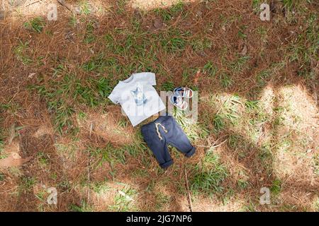 Set di vestiti per bambini; foto su sfondo naturale. Foto Stock