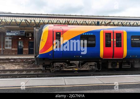 La stazione di Basingstoke con il treno della ferrovia sud occidentale ha fermato, Hampshire, Inghilterra, Regno Unito Foto Stock