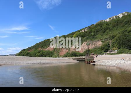 La foce del fiume Ax come incontra il mare a Axmouth nel Devon. È piuttosto stretto e diventa un torrente infuriante quando la marea cambia Foto Stock