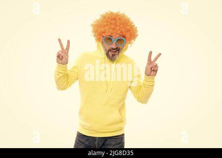 Solo cool dude. Pazzo uomo mostrare segni di pace. Moda cool. Aspetto nerdy. Capelli bunky wig Foto Stock