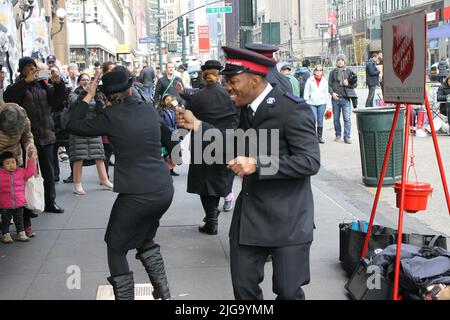 I volontari dell'Esercito della salvezza ballano sulla 34th Street, New York, USA Foto Stock