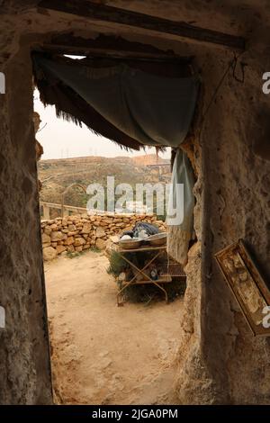 Vista dall'interno della grotta naturale accanto alla porta con tenda Foto Stock
