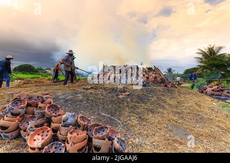 villaggio tradizionale in ceramica, gli artigiani bruciano prodotti, che sono fatti con le loro mani in modo tradizionale con legno e paglia di riso all'aperto Foto Stock