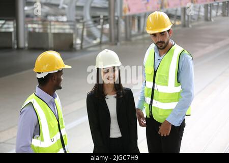 Architect, civil engineer and worker looking at plans and blueprints, discussing issues at the construction site. Stock Photo