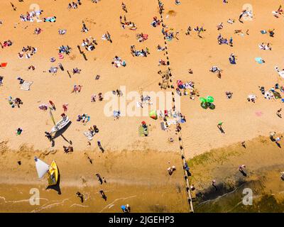 Portobello, Edimburgo, Scozia, Regno Unito. 10 luglio 2022. Una vista aerea di migliaia di amanti del sole sulla spiaggia di Portobello oggi con l'aumento delle temperature a 27C. La famosa spiaggia e il lungomare fuori Edimburgo sono stati a lungo un magnete per gli abitanti della città in estate. Iain Masterton/Alamy Live News Foto Stock