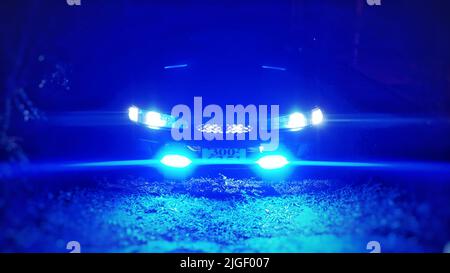 I fari blu illuminati di un'auto Foto Stock