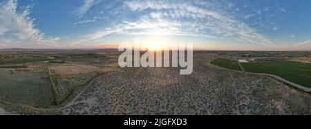 Tramonto del deserto che mostra l'intera di una piccola città agricola Foto Stock