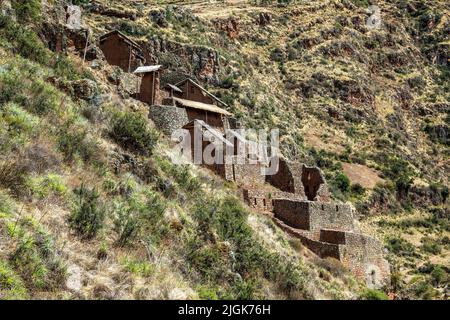 Edifici sul lato della scogliera, rovine Pisac Inca, Pisac, Cusco, Perù Foto Stock