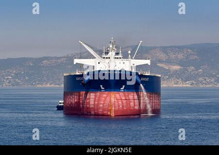 Atene, Grecia - Maggio 2022: Dirigiti verso la grande nave da carico Seavelvet all'ancora al largo della costa di Atene in attesa della sua fessura nei moli della città Foto Stock