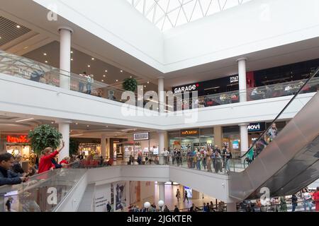 Grodno, Bielorussia - 01 settembre 2020: I visitatori camminano attraverso i piani e si spostano su scale mobili e ascensori nel centro commerciale Triniti. Foto Stock