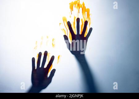 Composizione della forma delle mani nere con macchie di sangue su sfondo bianco Foto Stock