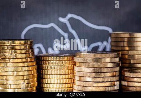 Volatilità sul mercato azionario. Toro e orso con pile di monete. Foto Stock