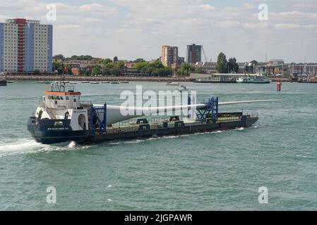 Portsmouth, Inghilterra meridionale, Regno Unito. 2022. Pala della turbina eolica come carico sulla pala corridore due nave in corso nel porto di Portsmouth. Sfondo di Gosport, Foto Stock