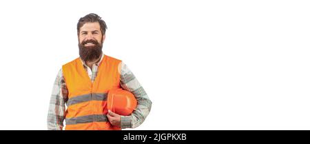 Uomo barbuto lavoratore in costruzione casco o elmetto. Ritratto di un costruttore sorridente. Lavoratore in uniforme di costruzione. Uomo costruttori, industria Foto Stock