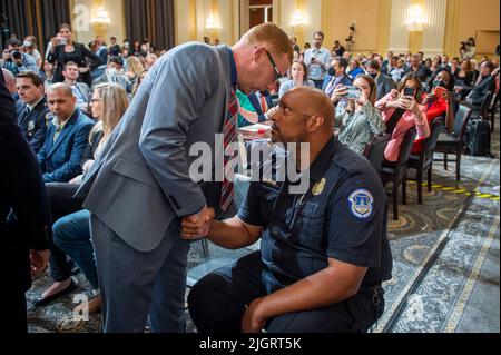 Washington, DC, Stati Uniti, 12 luglio 2022. Stephen Ayres, a sinistra, che si è dichiarato colpevole di entrare illegalmente nel Campidoglio il 6 gennaio, ha discusso con l'ufficiale della polizia del Campidoglio americano Harry Dunn, a destra, dopo il giorno sette del Comitato di selezione della Camera degli Stati Uniti per indagare sull'attacco del 6th gennaio all'udienza del Campidoglio degli Stati Uniti a Capitol Hill a Washington, DC il 12 luglio 2022. Credit: Rod Lammey/CNP /MediaPunch Foto Stock