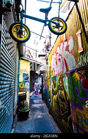 Una donna tailandese camminando per uno stretto vicolo in Khao San area di Bangkok. Foto Stock