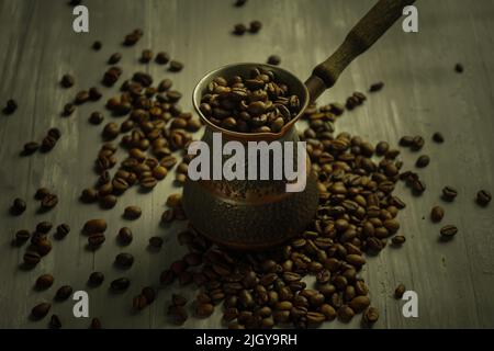 Chicchi di caffè tostati neri. Caffè Cezva Cup vetro rustico stile turco macinato caffè Foto Stock