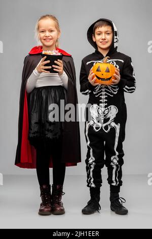 bambini felici in costumi di halloween con caramelle Foto Stock