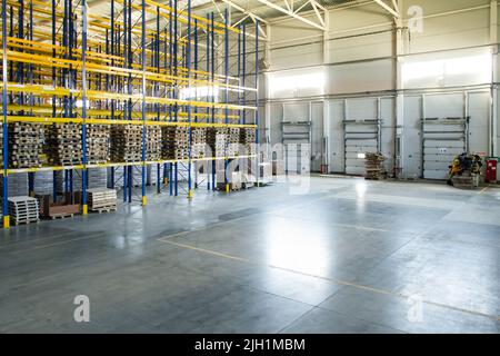 Vista generale dei cancelli di carico all'interno del magazzino. Interno di un magazzino moderno. Processo di caricamento del carrello Foto Stock