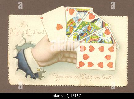 Chromolithographed die cut punning biglietto di auguri di Natale mostrando una mano di giocare carte circa 1898 Foto Stock